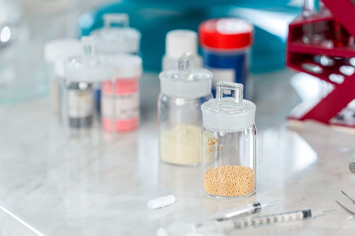 Two coating bottles standing side by side on a clean workbench in daylight