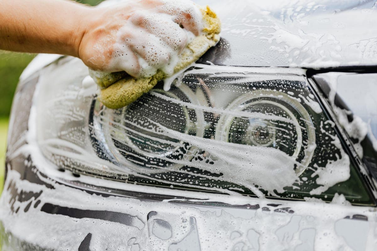 A soapy wash sponge on the side of a car