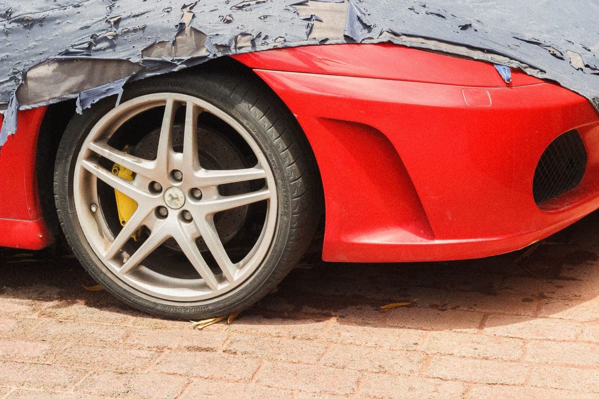 Water beading on clear protective film over a car's front bumper
