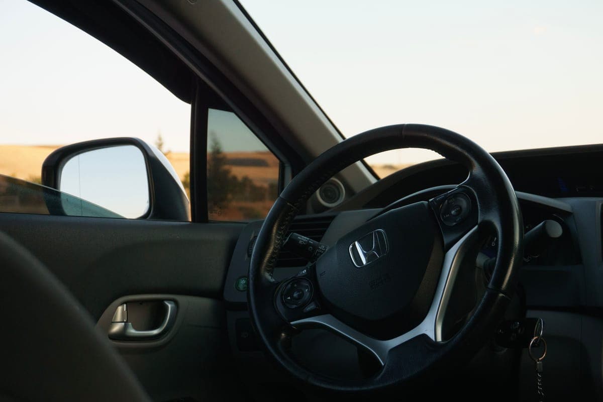 Sunlight falling across a clean matte car dashboard