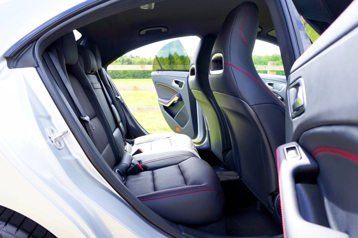 A clean car interior with the windows down and sunlight coming through