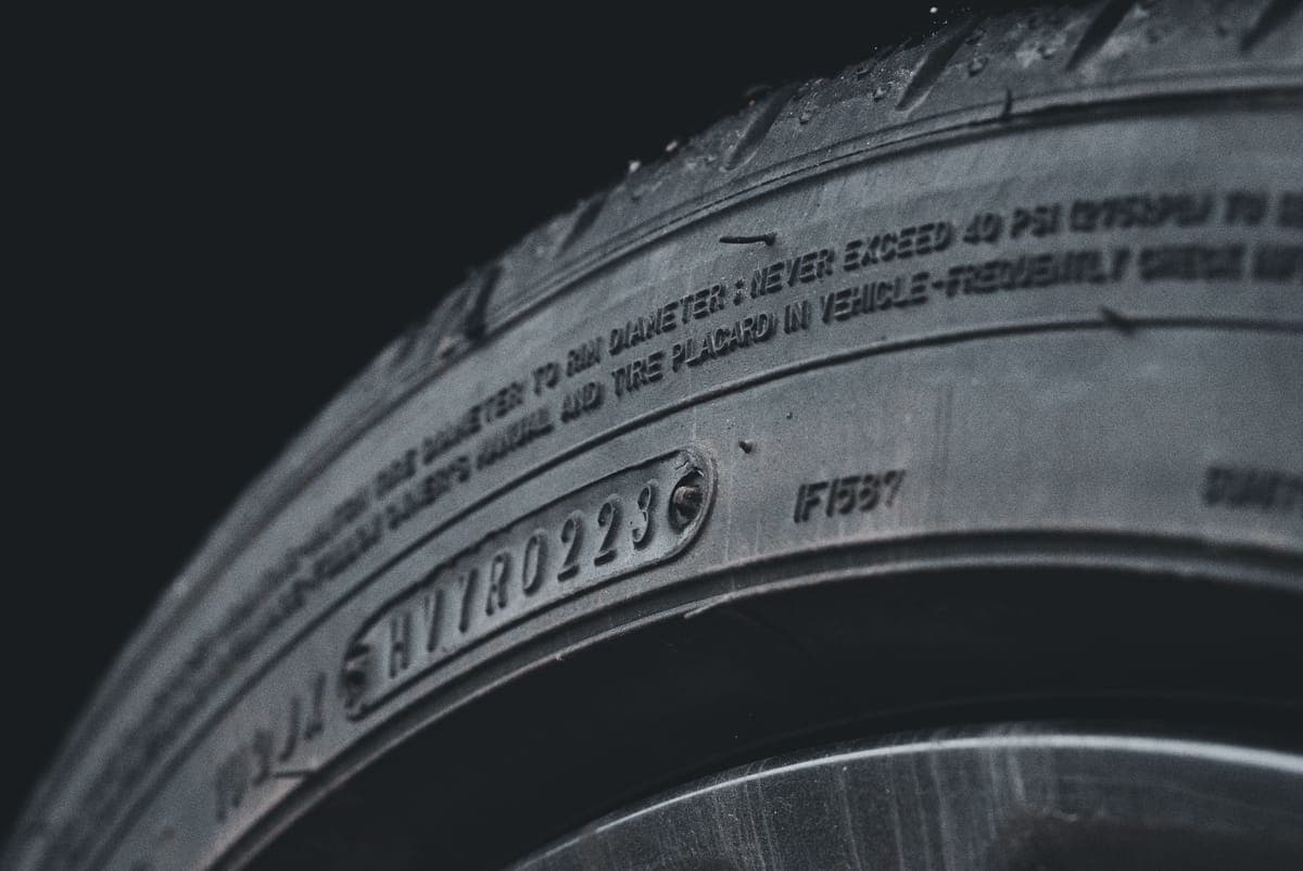 A tire sidewall being dressed with a foam applicator pad