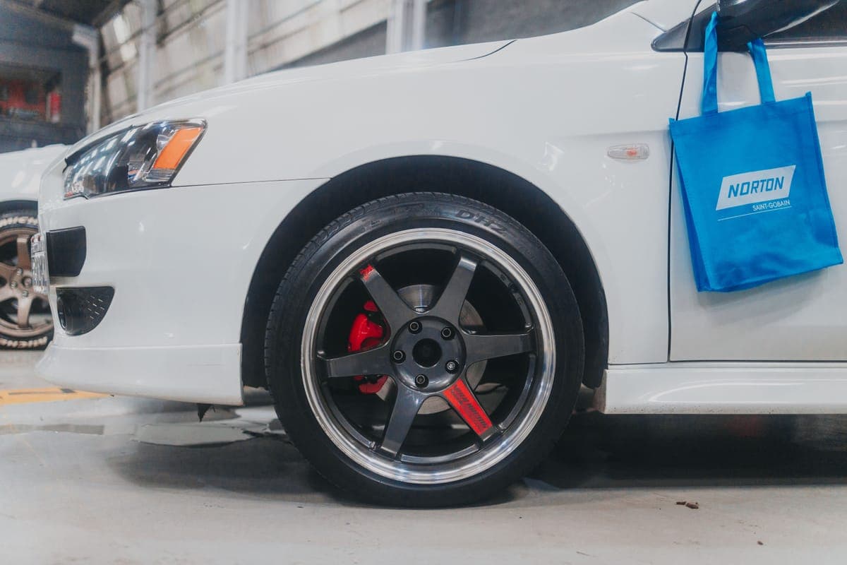 A freshly dressed tire and clean alloy wheel photographed in bright daylight