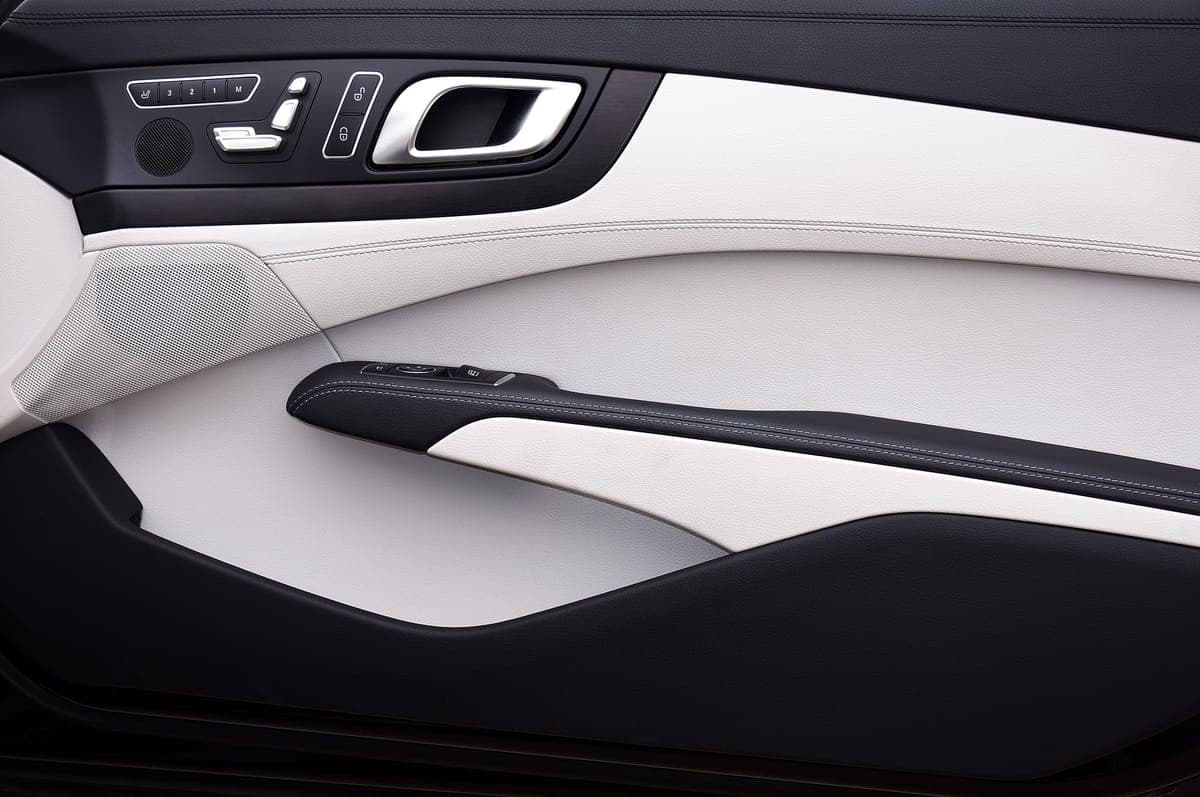 Restored black exterior trim on a clean light-colored car