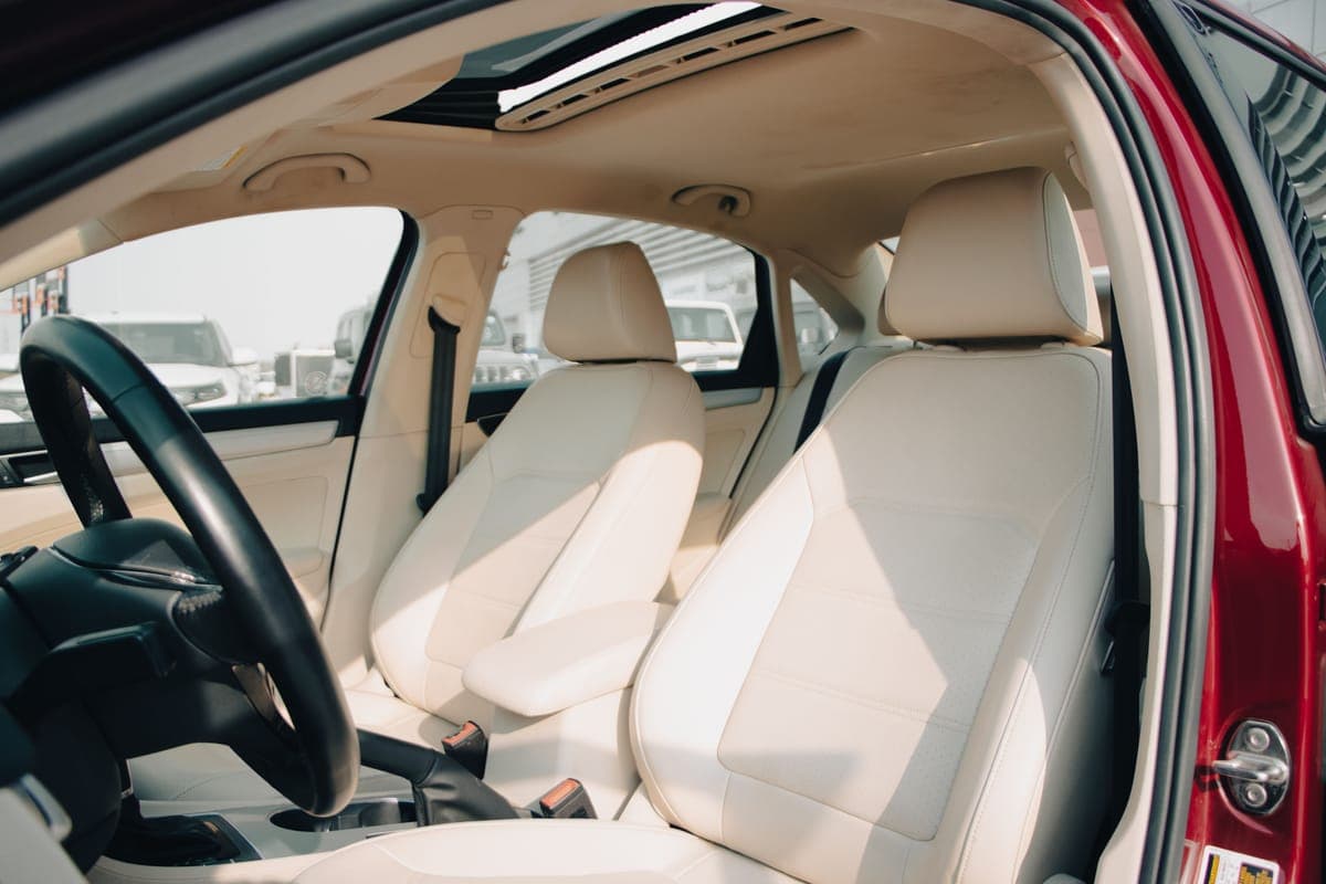 A car interior with cloth and leather surfaces in soft daylight