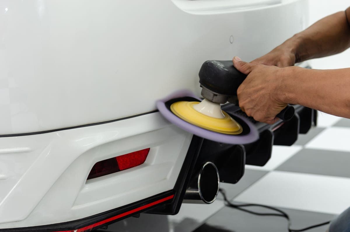 A small polisher working on a car bumper