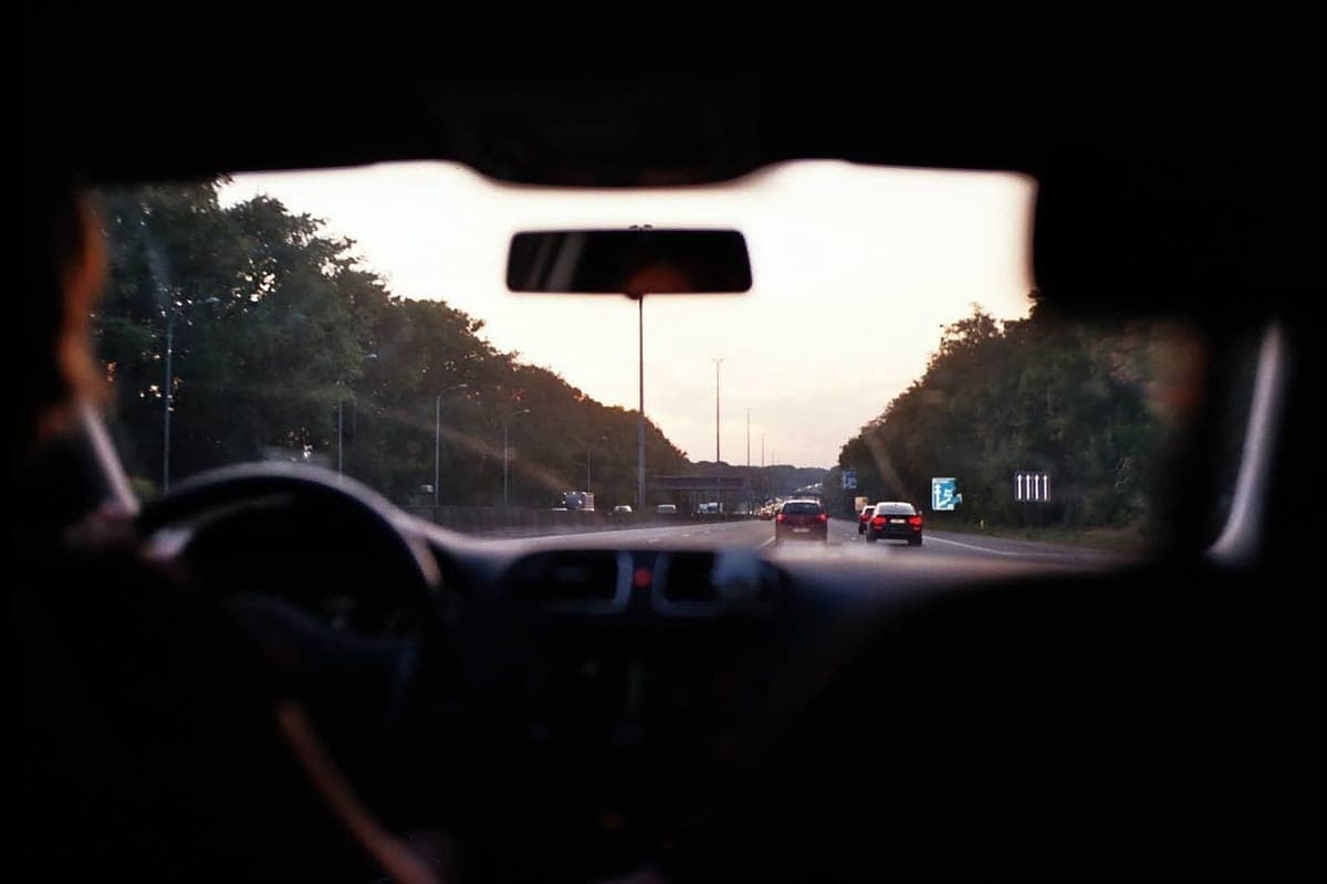 The fabric headliner of a car seen from the back seat