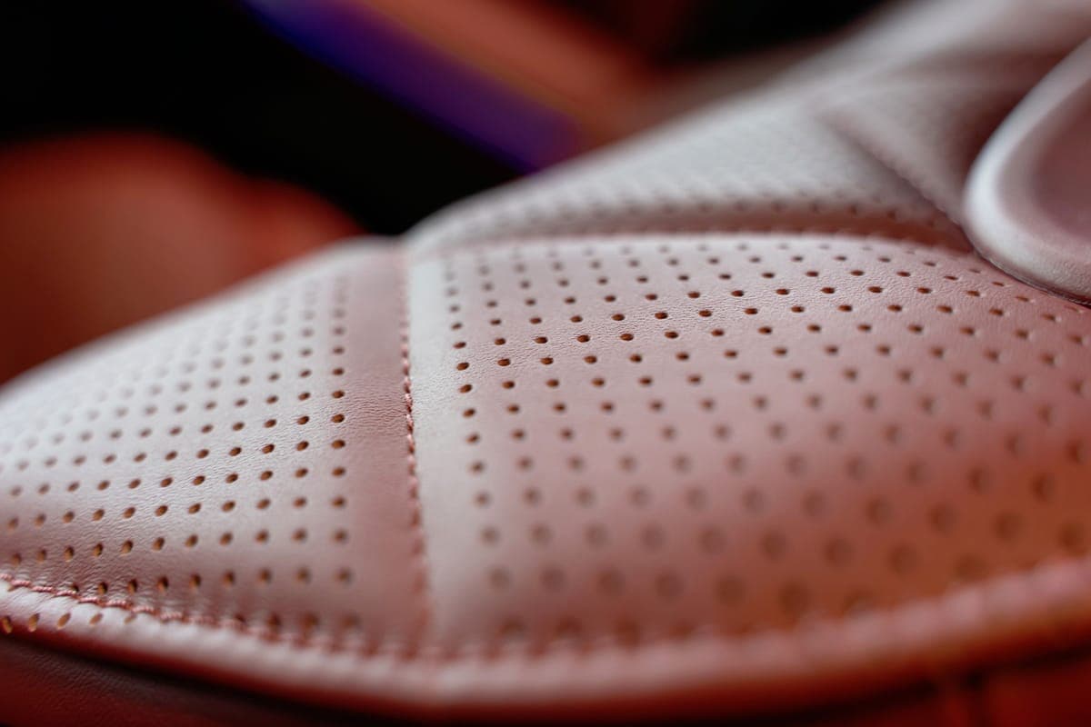 Close-up of perforated leather upholstery on a car seat