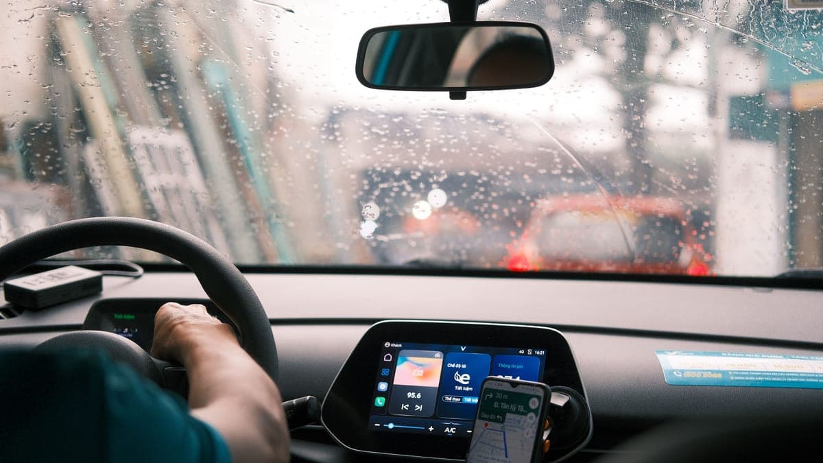 The view through a car windshield from the driver's seat on a wet day