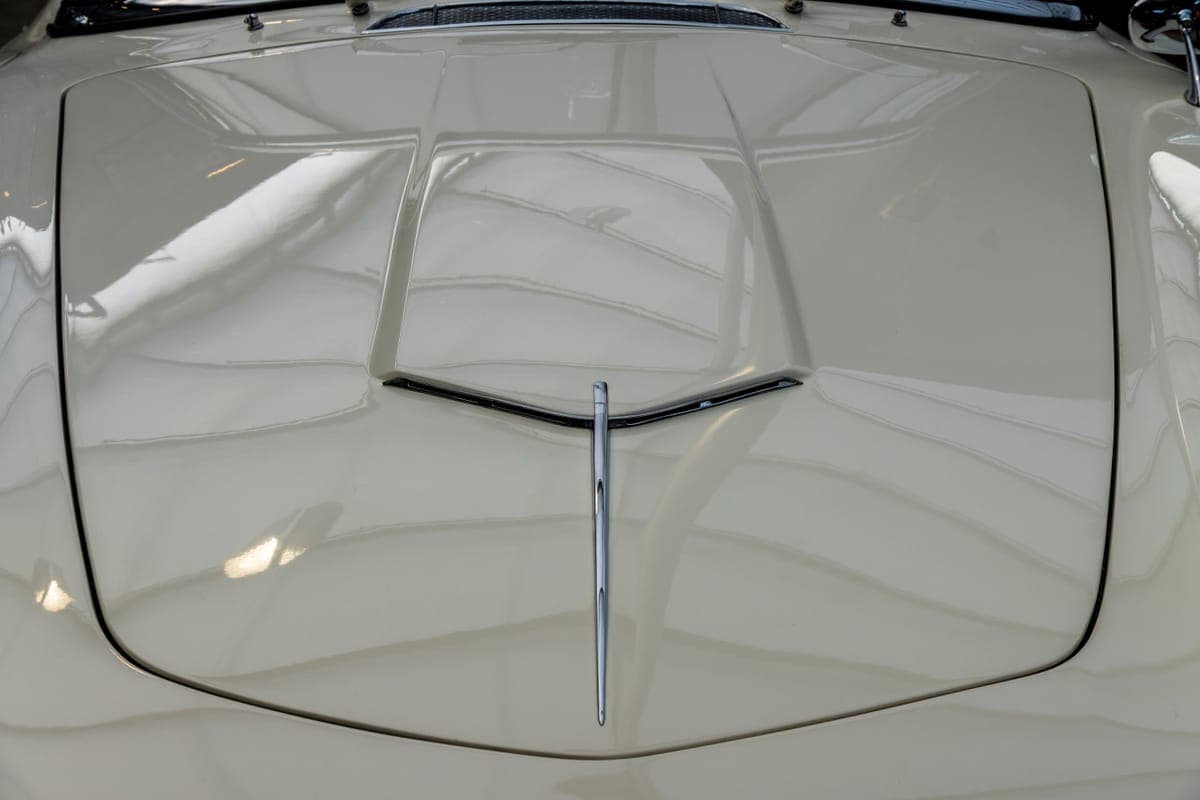 A polished panel half-corrected under an inspection light